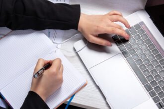 A girl making notes before writing assignments