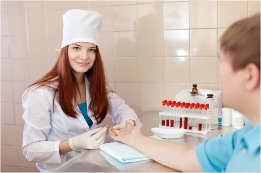 A phlebotomist drawing blood from a patient