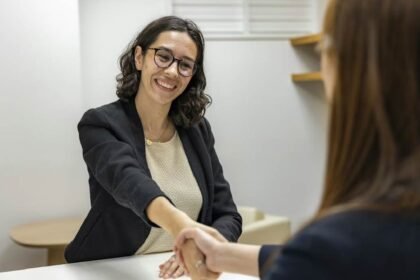 A young woman shaking hands with the recruiting manager after the interview.