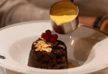 Sticky toffee pudding with warm custard poured over a rich dessert at one of the best hidden restaurants in London locals swear by for unique dining experiences.