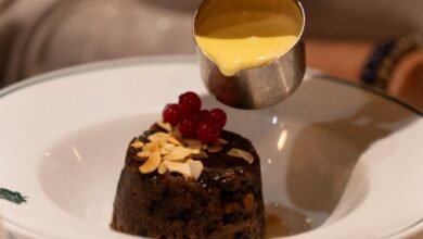 Sticky toffee pudding with warm custard poured over a rich dessert at one of the best hidden restaurants in London locals swear by for unique dining experiences.