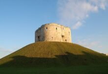 Clifford's Tower, a medieval stone castle keep on a grassy mound in York, North Yorkshire, England, a landmark to explore on a historic weekend break