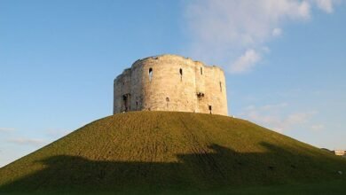 Clifford's Tower, a medieval stone castle keep on a grassy mound in York, North Yorkshire, England, a landmark to explore on a historic weekend break